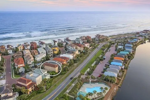 a aerial view of a house with yard and outdoor seating