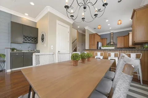 a kitchen with granite countertop wooden cabinets and stainless steel appliances