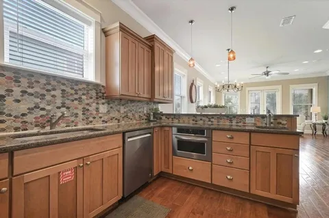 a kitchen with stainless steel appliances granite countertop a stove a refrigerator and a microwave