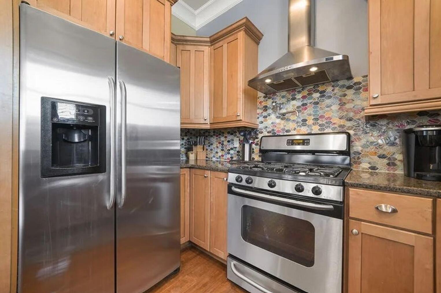 4836 Ocean Boulevard Destin, FL 32541 - Photo 9 of 44 a kitchen with stainless steel appliances granite countertop a stove a refrigerator and a microwave
