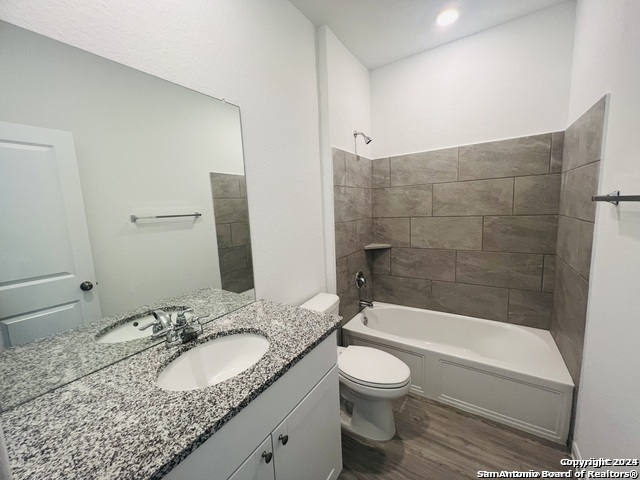 32141 Morels Avenue Bulverde, TX 78163 - Photo 16 of 22 a bathroom with a granite countertop sink a toilet and bathtub