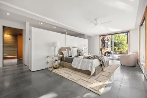 a spacious bedroom with two beds and glass windows