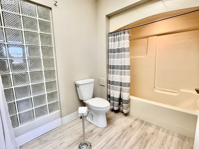 a bathroom with a toilet and a shower