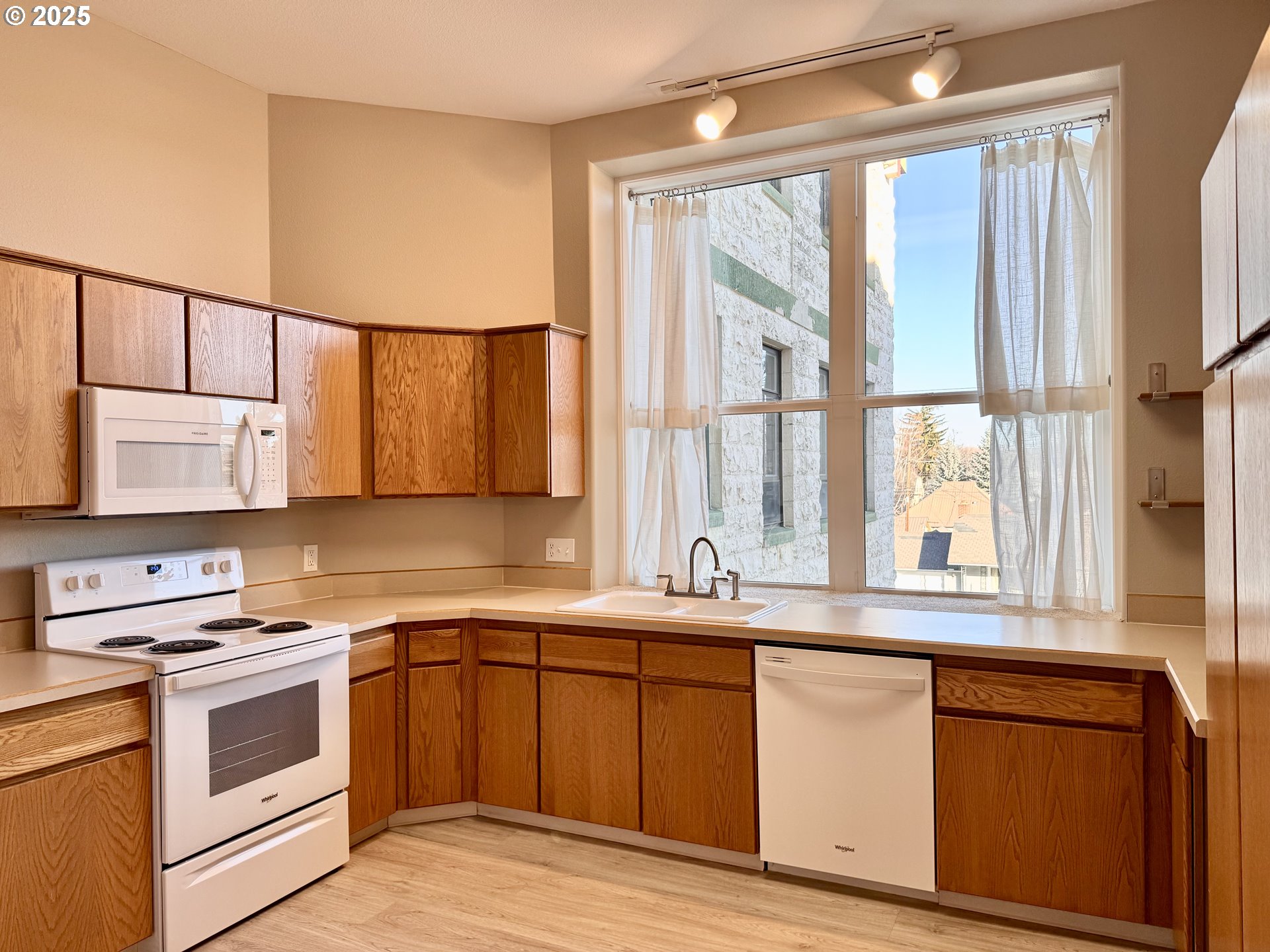 2365 4th Street, Unit 205 Baker City, OR 97814 - Photo 8 of 23 a kitchen with stainless steel appliances a sink a stove and a window