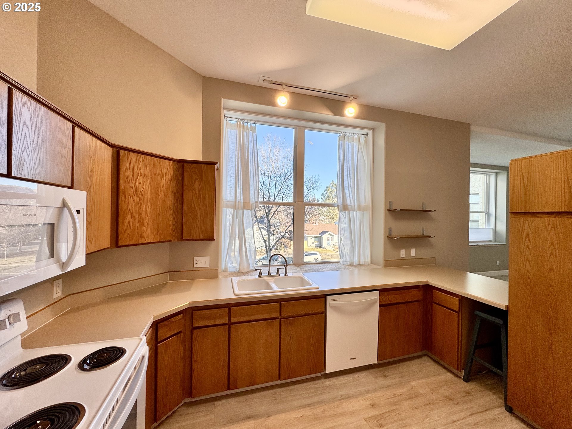 2365 4th Street, Unit 205 Baker City, OR 97814 - Photo 9 of 23 a kitchen with a sink stove and cabinets