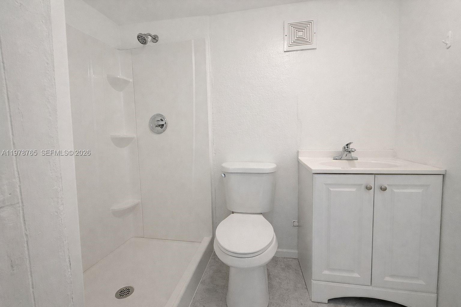 2227 Southwest 2nd Terrace, Unit 2227 Miami, FL 33135 - Photo 7 of 10 a bathroom with a sink a toilet and shower