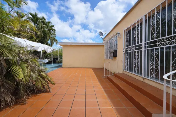 a view of backyard with patio