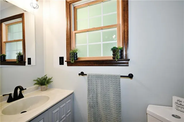 a bathroom with a sink a mirror and a window