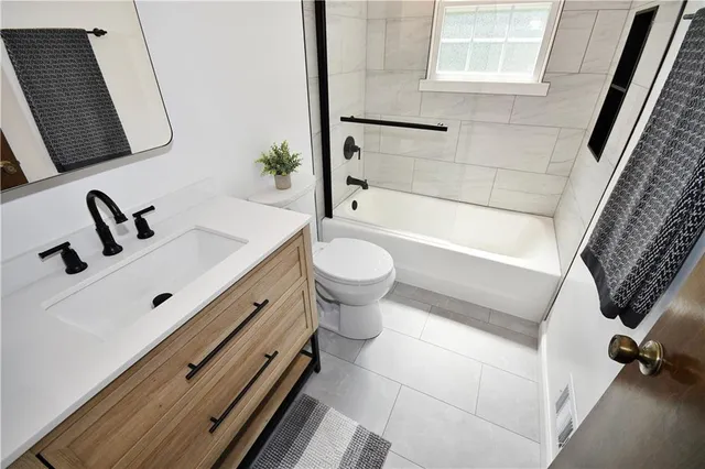 a bathroom with a sink a toilet and a bathtub