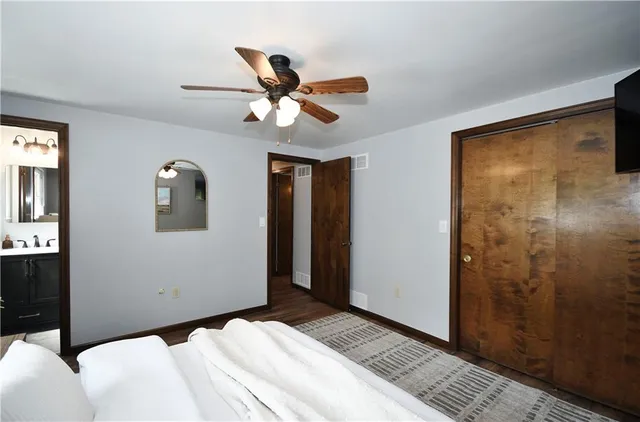 a bedroom with a bed and a mirror