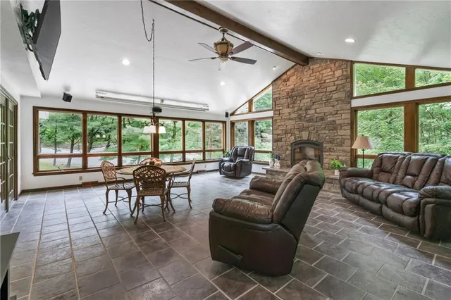 a living room with furniture and large windows