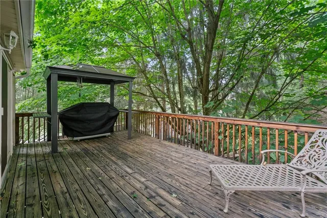 a view of balcony with wooden floor and outdoor seating