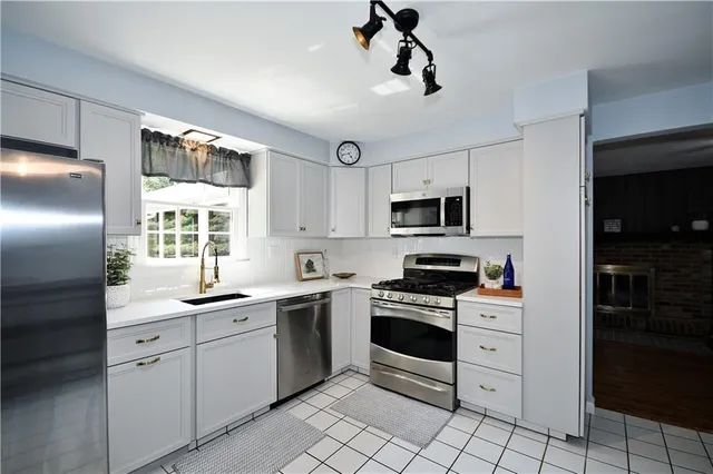 a kitchen with a sink appliances and cabinets