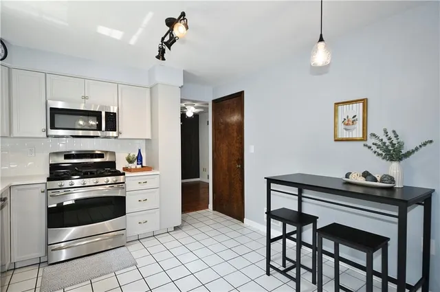 a kitchen with stainless steel appliances a stove a sink refrigerator and cabinets