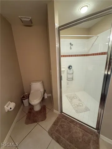 a bedroom with a bed and a mirror