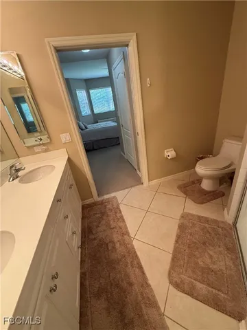 a view of a livingroom with furniture wooden floor and a large window