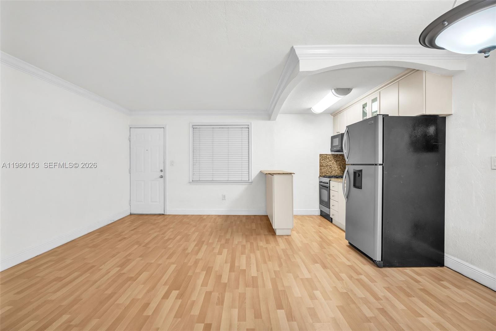 3245 Virginia Street, Unit 39 Miami, FL 33133 - Photo 13 of 25 a view of a kitchen with a refrigerator and a sink