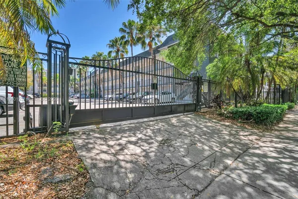 a view of a backyard with iron fence