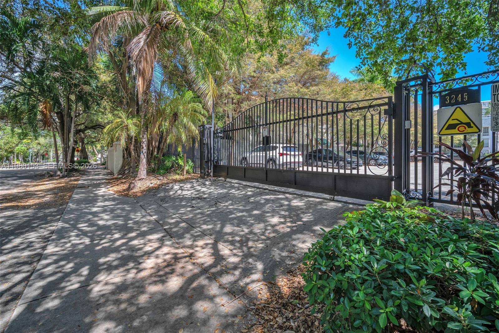 3245 Virginia Street, Unit 39 Miami, FL 33133 - Photo 15 of 25 a view of a backyard with iron fence
