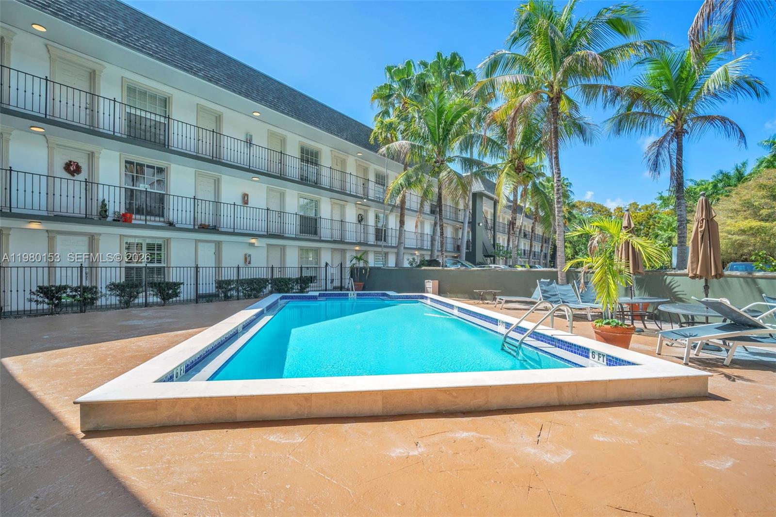 3245 Virginia Street, Unit 39 Miami, FL 33133 - Photo 21 of 25 a small pool with a couple of palm trees