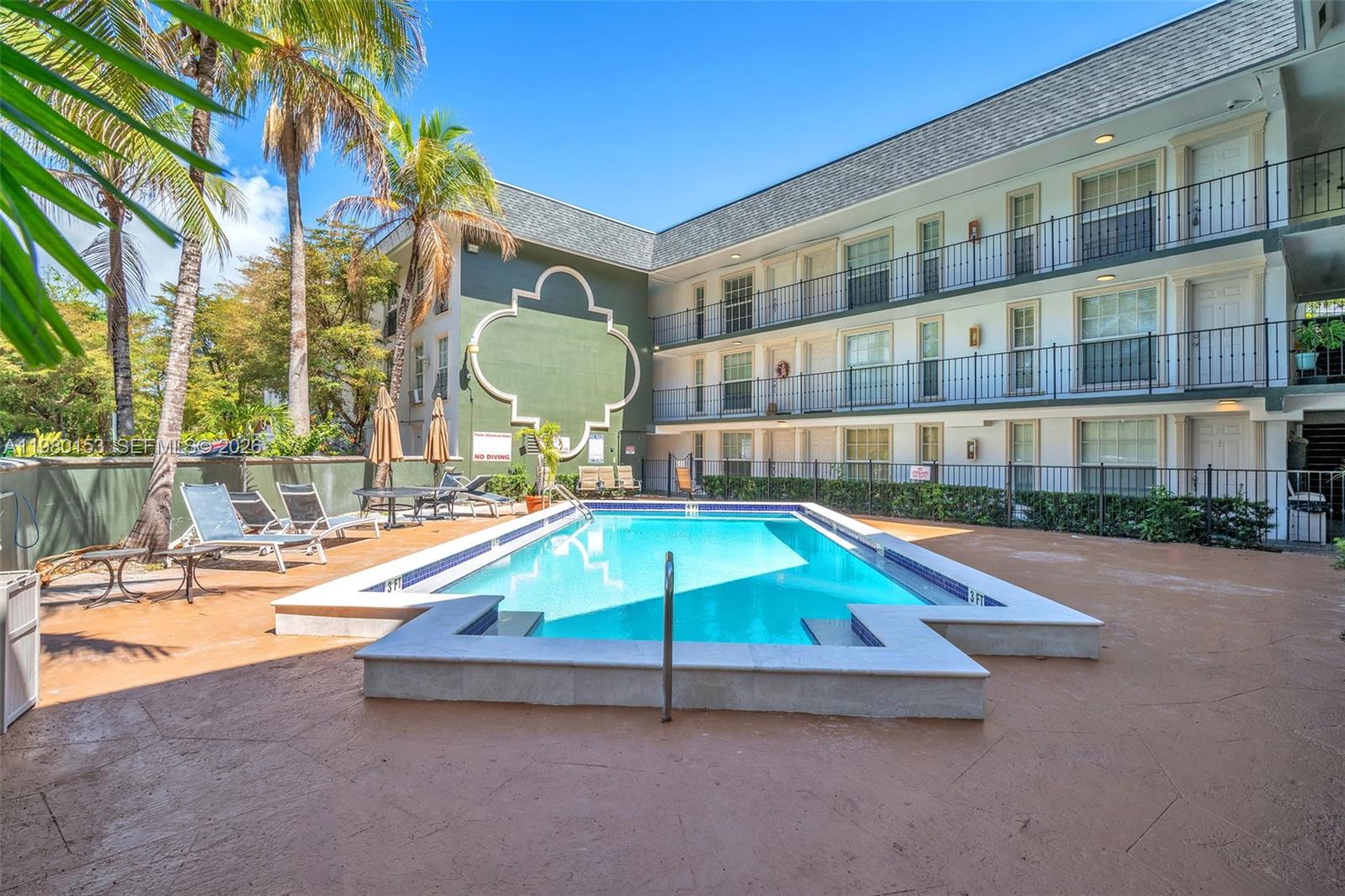 3245 Virginia Street, Unit 39 Miami, FL 33133 - Photo 23 of 25 a swimming pool with outdoor seating and yard