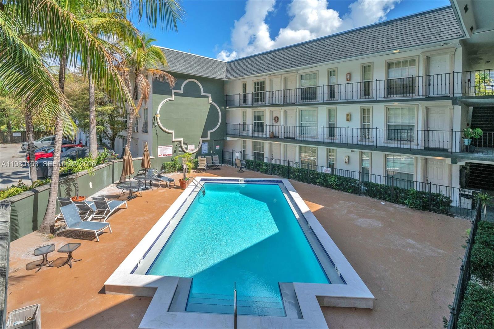 3245 Virginia Street, Unit 39 Miami, FL 33133 - Photo 24 of 25 a view of a swimming pool with a lounge chairs
