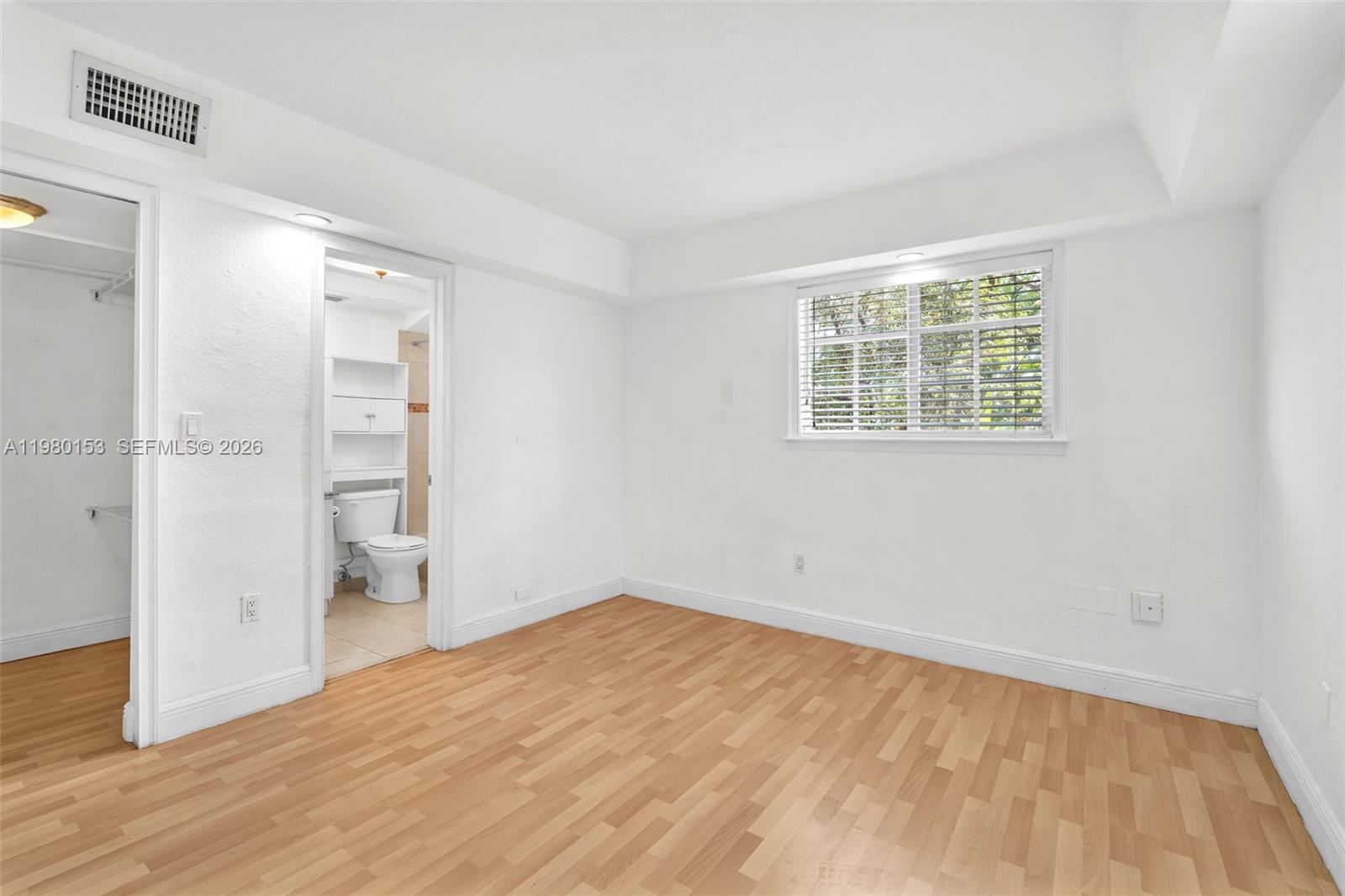 3245 Virginia Street, Unit 39 Miami, FL 33133 - Photo 6 of 25 wooden floor in an empty room with a window