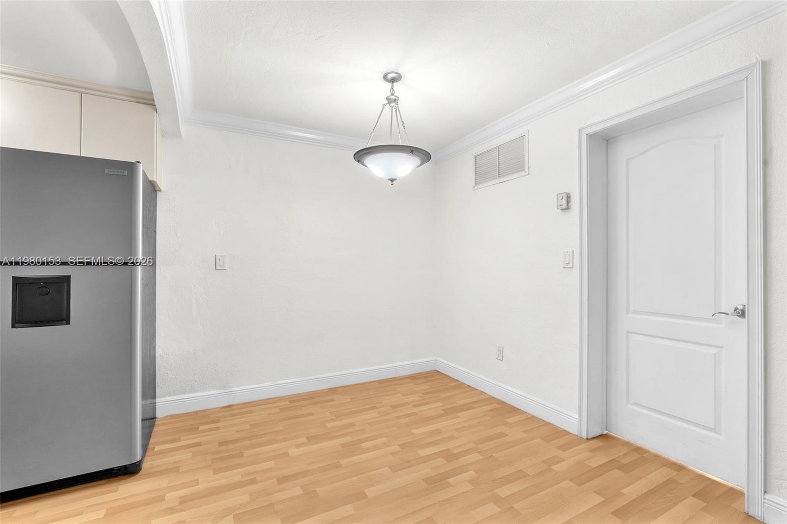 3245 Virginia Street, Unit 39 Miami, FL 33133 - Photo 8 of 25 a view of an empty room with wooden floor and a window