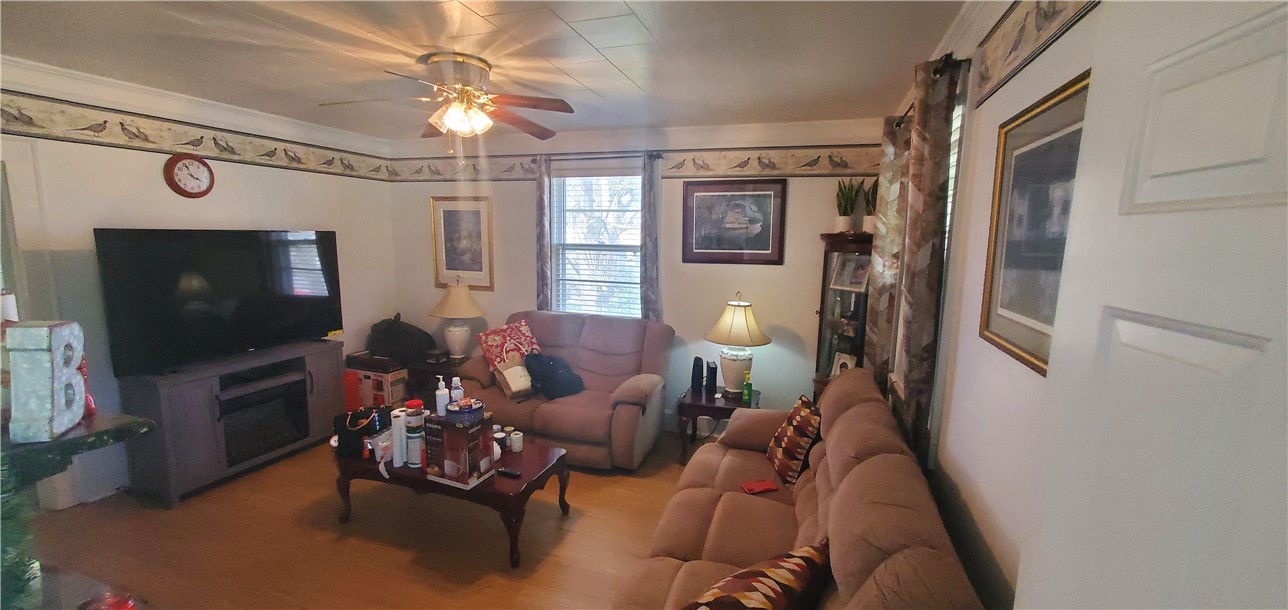 114 Hampton Street Pelzer, SC 29669 - Photo 16 of 21 This inviting living room features hardwood flooring and a functional ceiling fan.