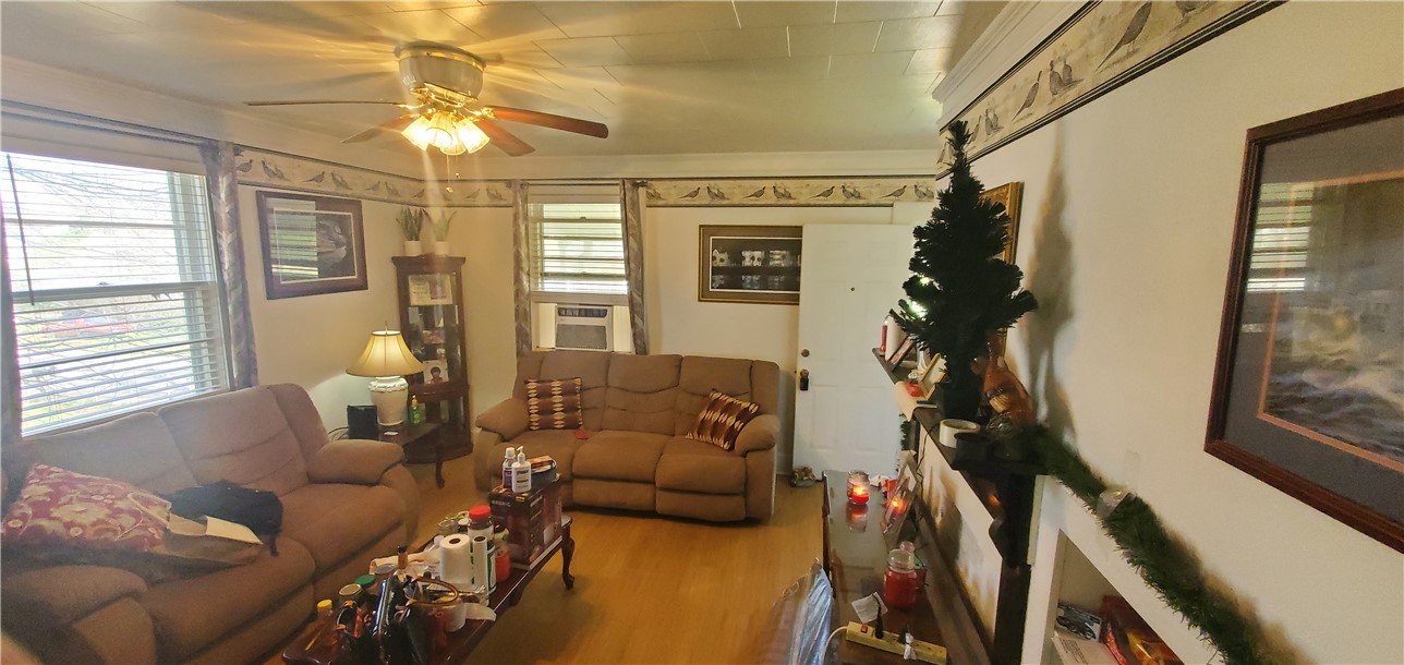 114 Hampton Street Pelzer, SC 29669 - Photo 17 of 21 This inviting living area features hardwood flooring and abundant natural light through multiple windows.