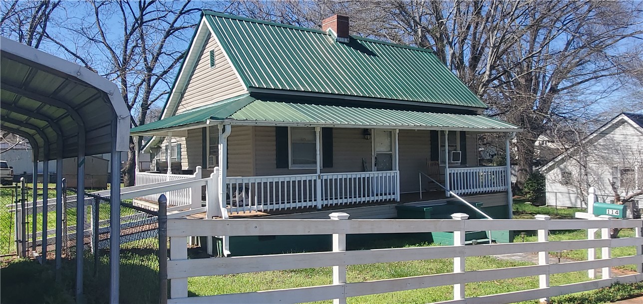 114 Hampton Street Pelzer, SC 29669 - Photo 2 of 21 This inviting home showcases a traditional exterior with a charming front porch.