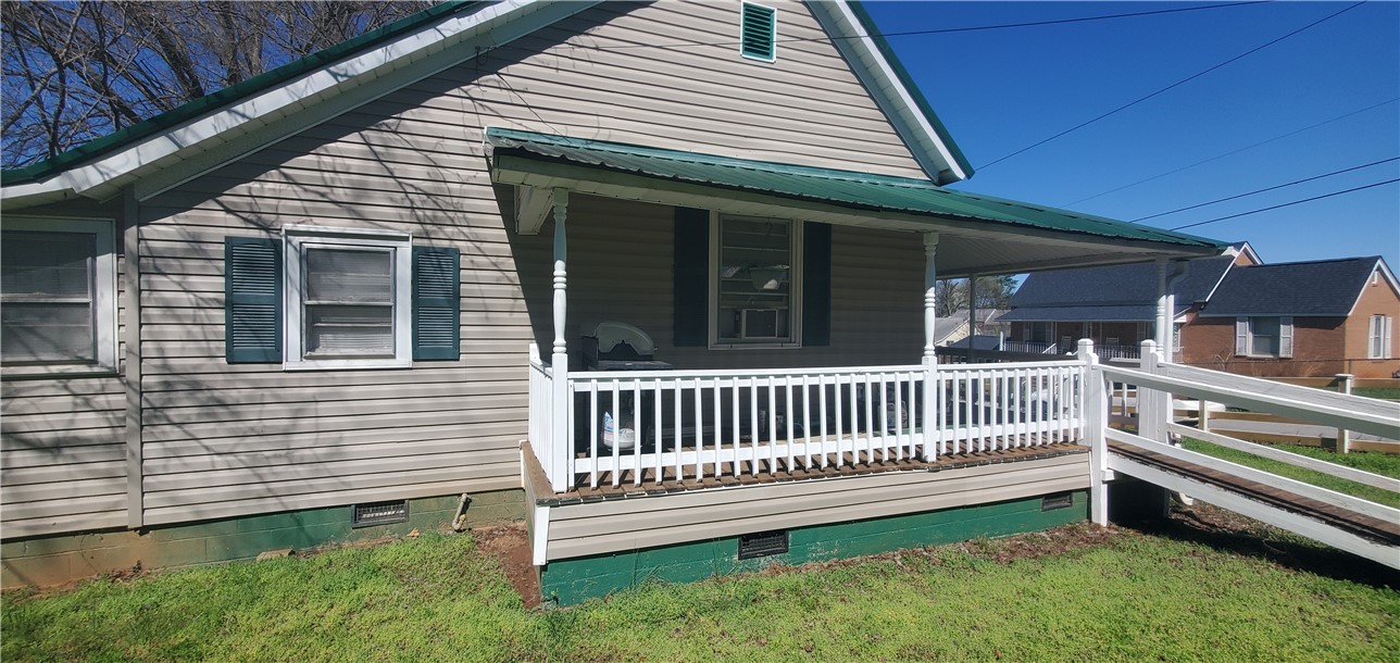 114 Hampton Street Pelzer, SC 29669 - Photo 5 of 21 This charming home features inviting curb appeal with a covered front porch and a convenient access ramp.