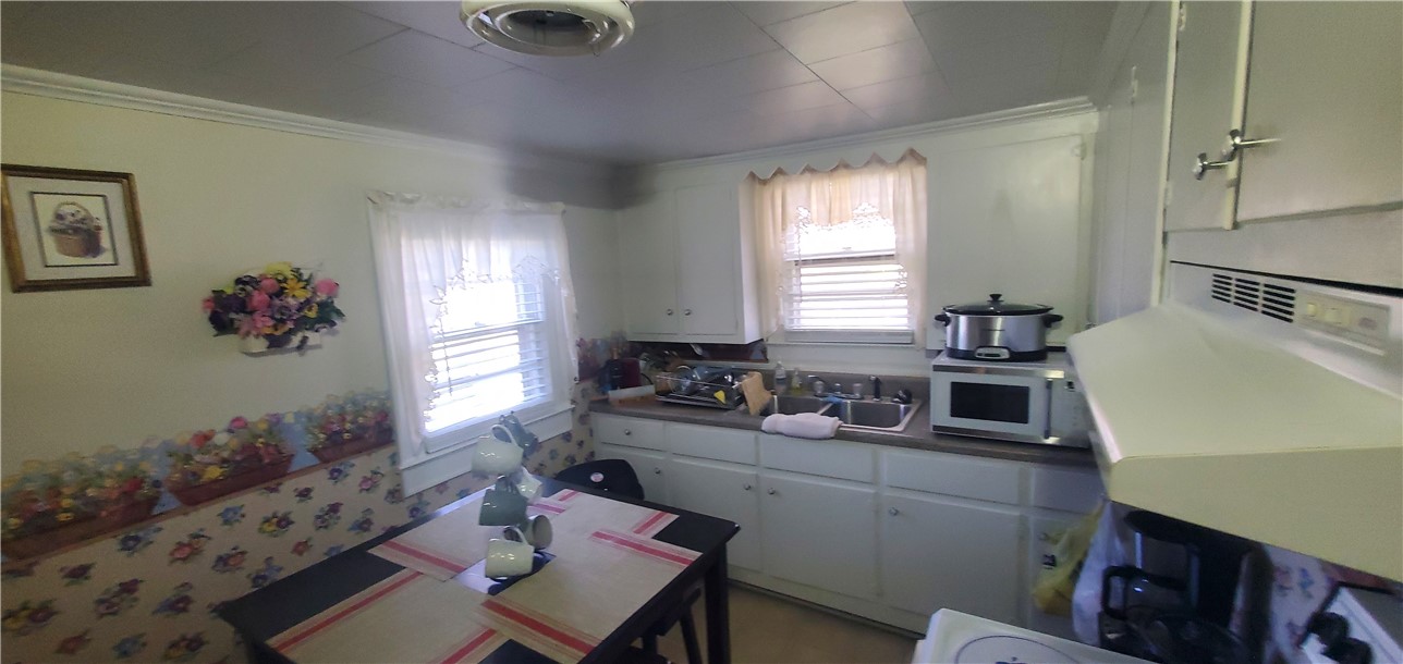 114 Hampton Street Pelzer, SC 29669 - Photo 6 of 21 This cozy kitchen offers an eat-in area, bright windows, and functional cabinetry.