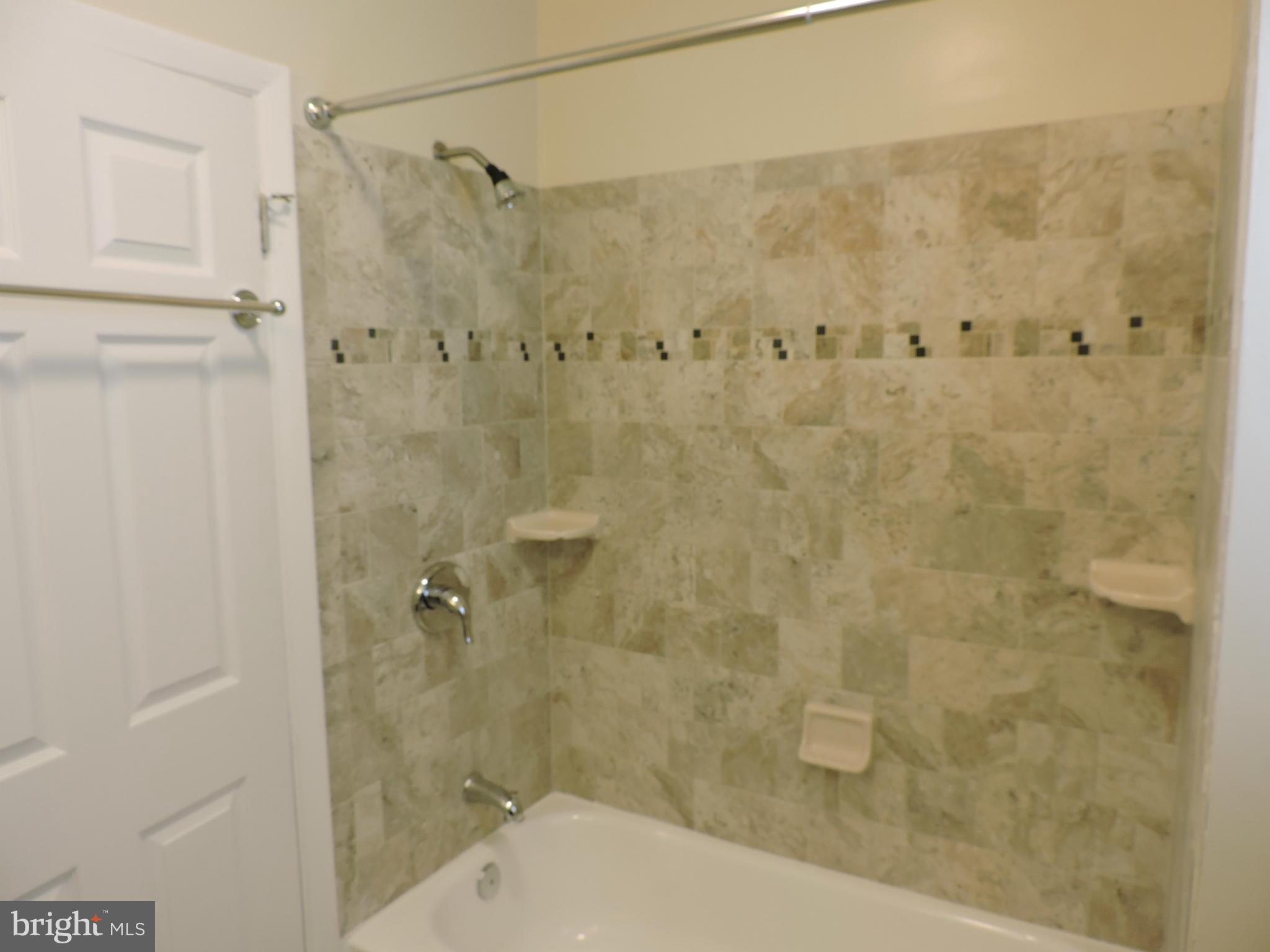 3911 Annapolis Road Halethorpe, MD 21227 - Photo 14 of 24 a bathroom with a shower and a toilet