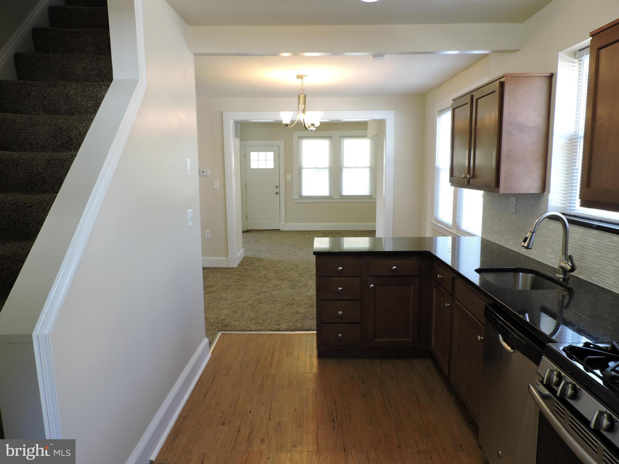 3911 Annapolis Road Halethorpe, MD 21227 - Photo 8 of 24 a kitchen with granite countertop a sink stove and cabinets