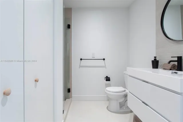 a bathroom with a toilet and a mirror