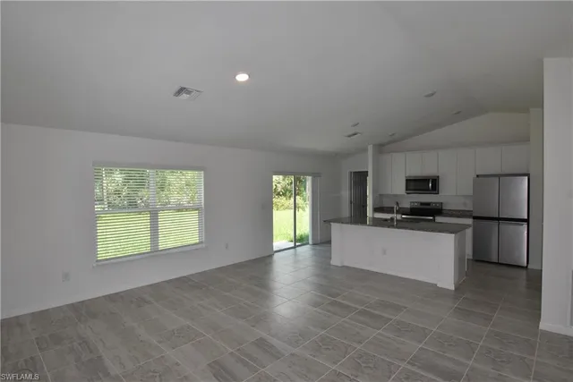 a kitchen with stainless steel appliances granite countertop a stove and a sink