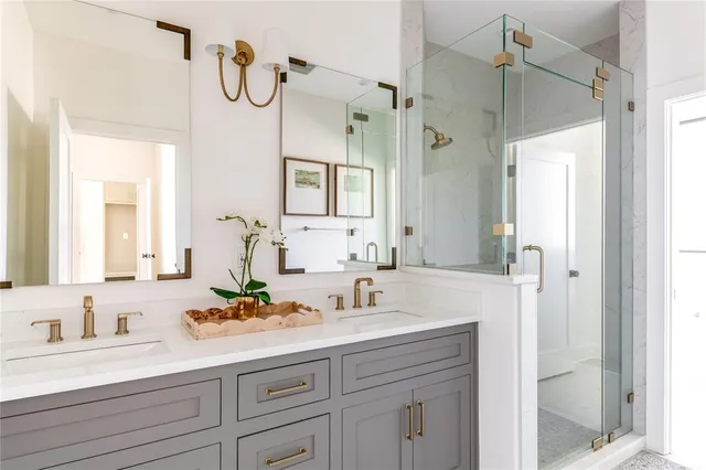 a bathroom with a sink vanity granite shower and a mirror