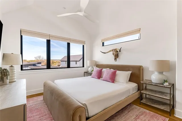 a bedroom with a large bed and a large window