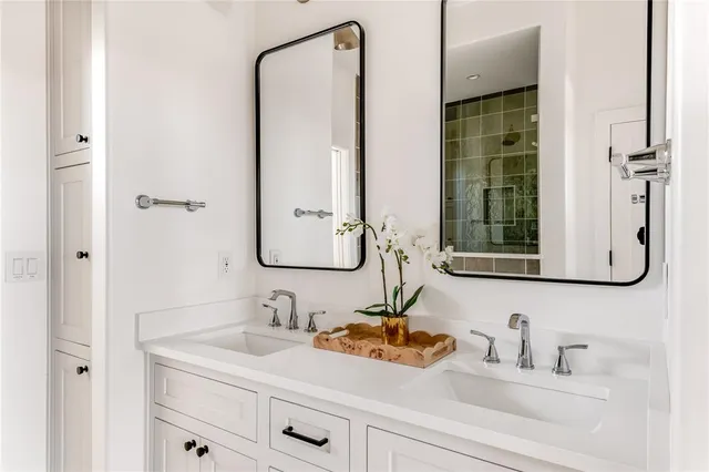 a bathroom with a sink and a mirror white cabinet