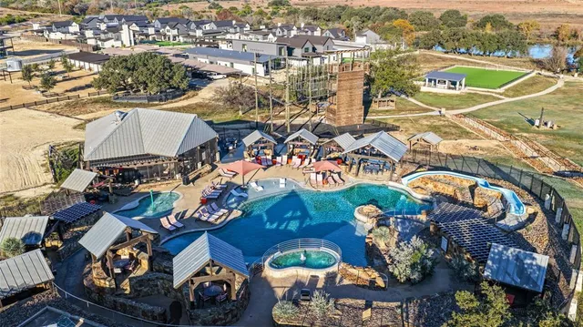 an aerial view of a house with a swimming pool yard and outdoor seating