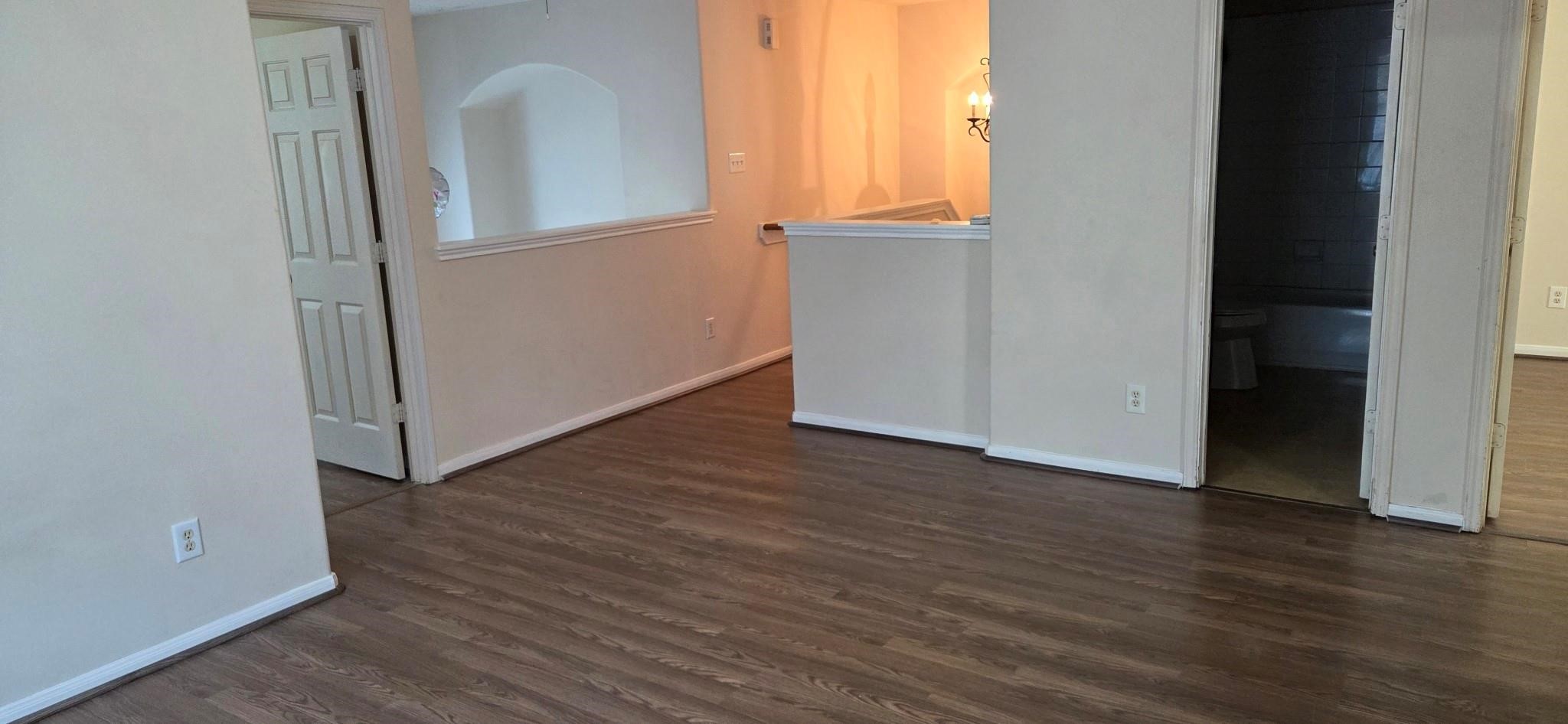 14127 Magnus Lane Houston, TX 77083 - Photo 15 of 16 an empty room with wooden floor and windows