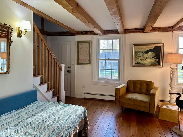 a bedroom with furniture and wooden floor
