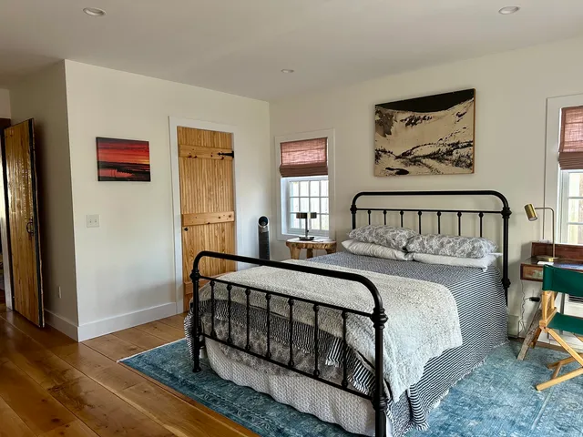 a bedroom with bed and a window