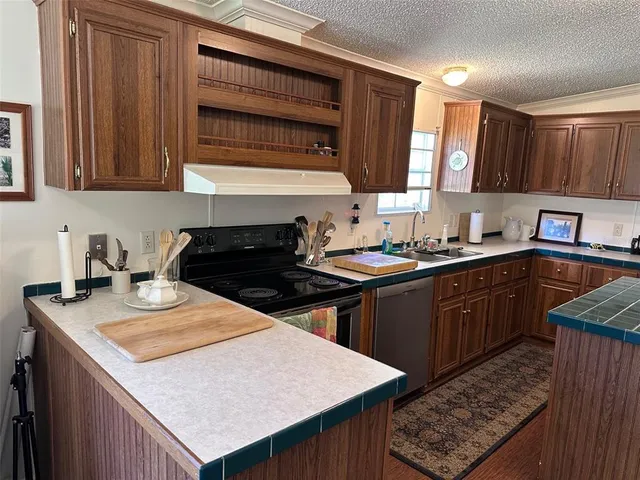 a kitchen with a sink stove and cabinets