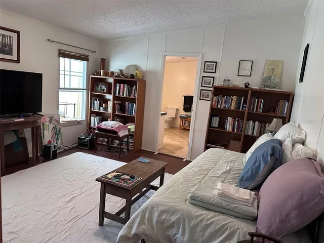 a living room with furniture a rug and a flat screen tv