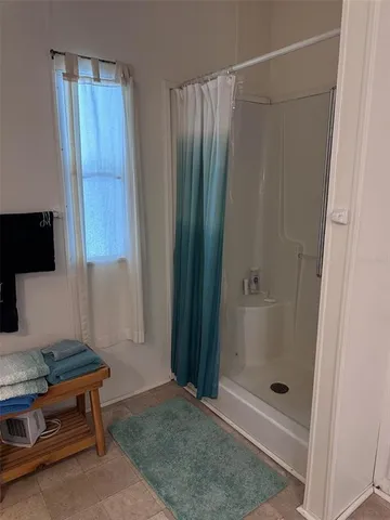 a bathroom with a shower and a sink