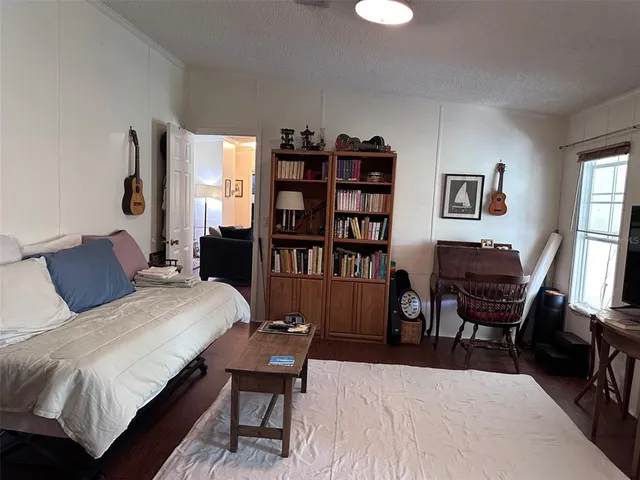 a bedroom with a bed a bookshelf and a bookshelf