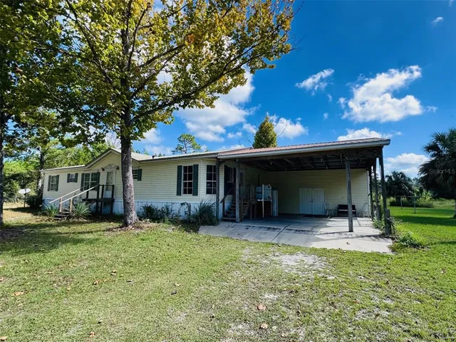 a house view with a sitting space and garden