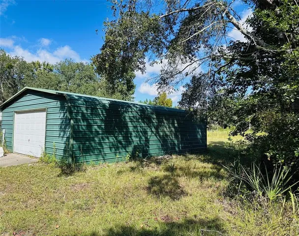 a view of a yard with a tree in the background
